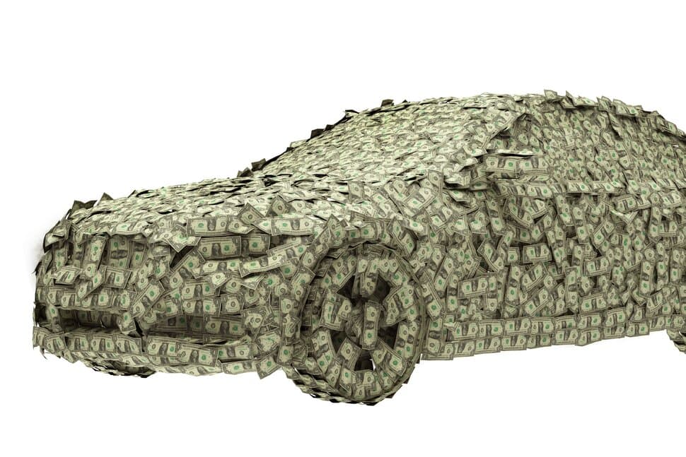 Professional detailer working on a car with cost analysis overlay